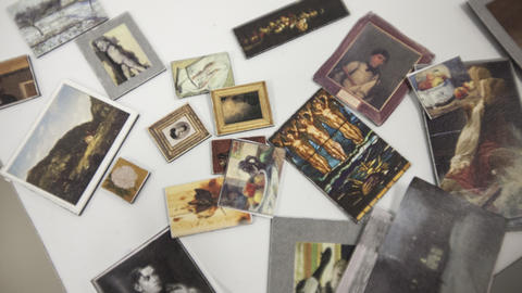 Table covered with assorted art miniatures and magnets