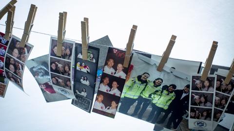 Collection of photos attached by clothespins to a length of line.