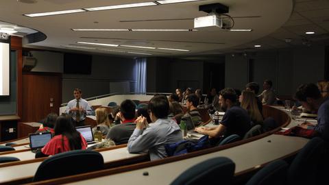 Instructor and students in a lecture-style classroom