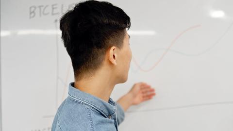 A man looking at a whiteboard