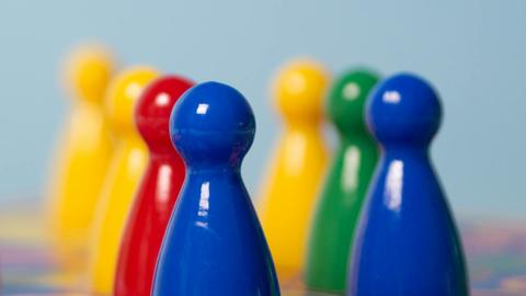 a group of plastic play figures in different colors