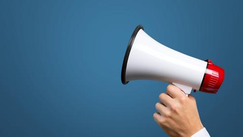 a hand holding a megaphone